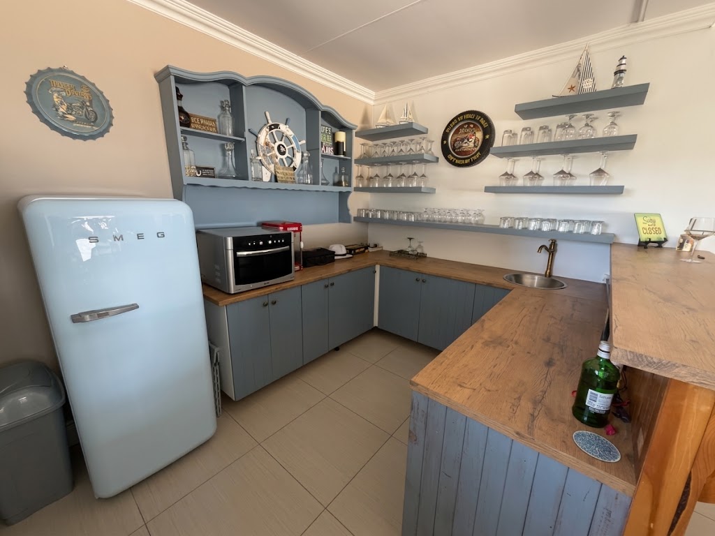 Family Bar Lounge bar with blue cabinetry and a retro refrigerator