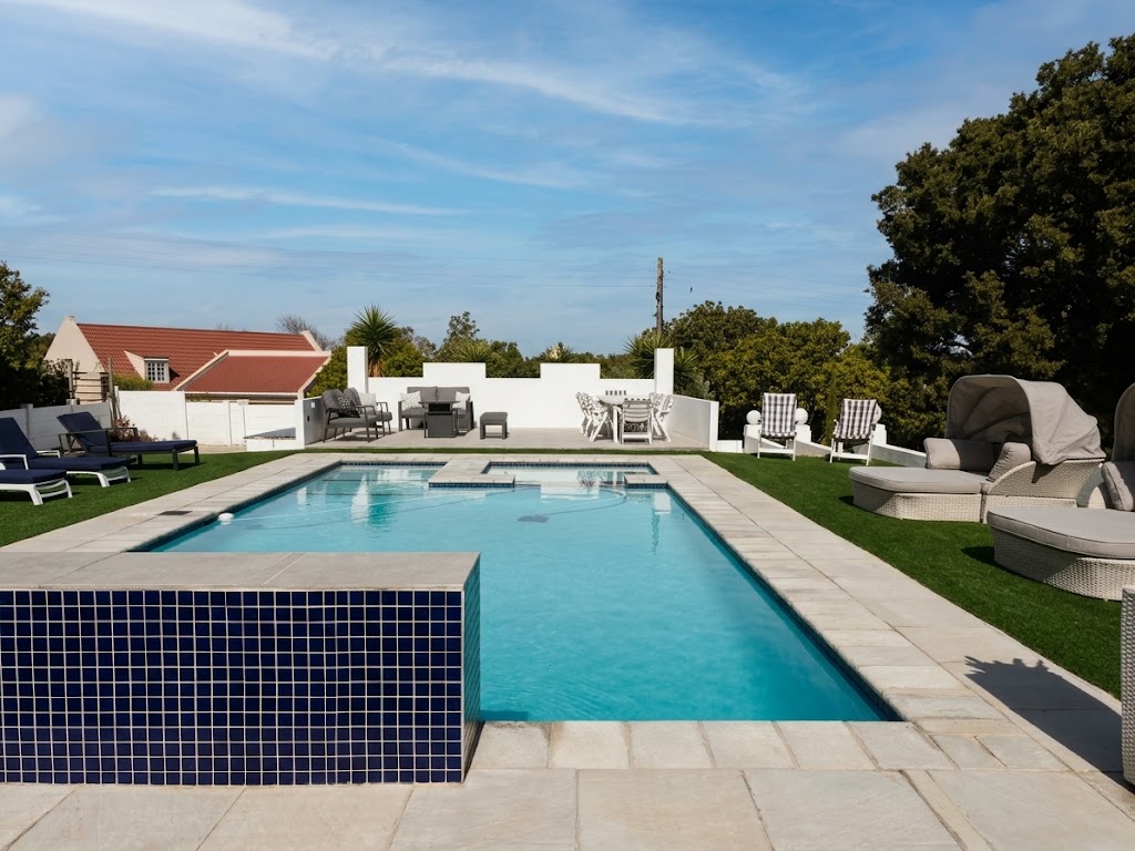The Oasis pool with turquoise water, sun loungers and outdoor seating