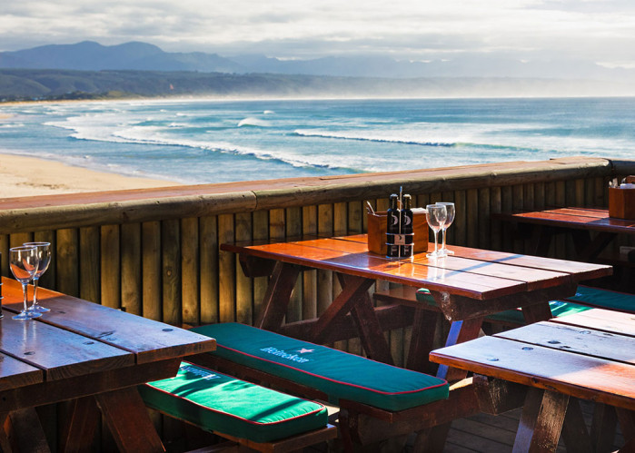 Wooden tables on the Lookout Deck above the surf at Lookout Beach
